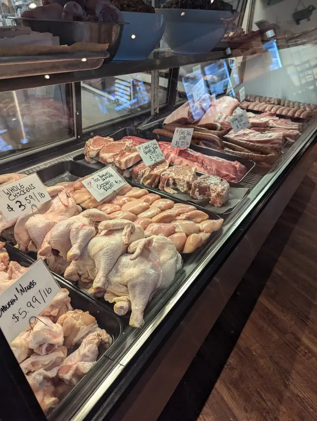 Whole chickens, chicken breast, pork chops, ribs and sausage in the case