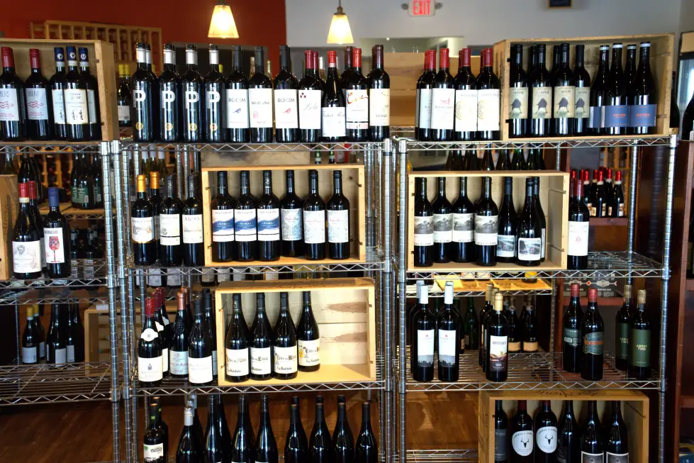 The wine wall at the back of The Butcher's Pantry, bottles shelved beside the shop floor