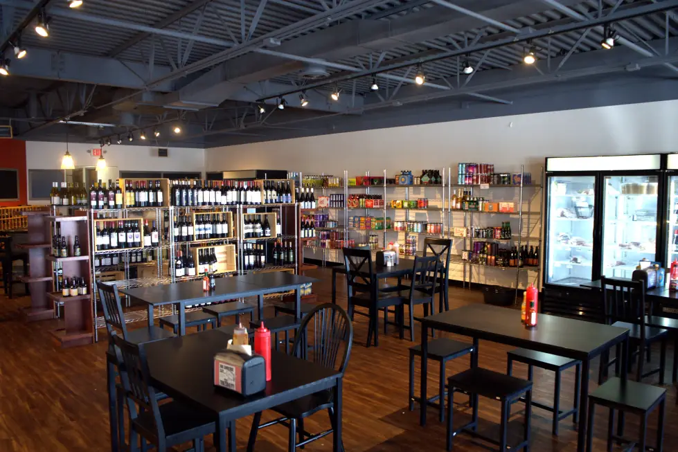 The dining room and retail floor at The Butcher's Pantry, tables, meat case and wine shelving in one room