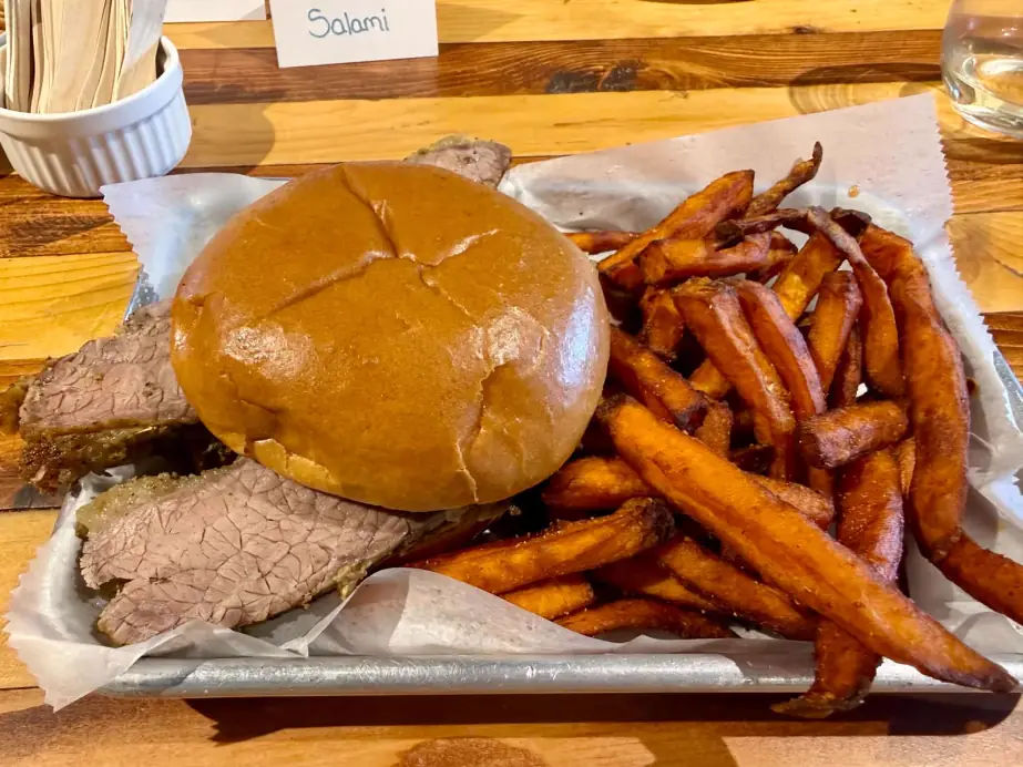 House smoked brisket sandwich with sweet potato fries