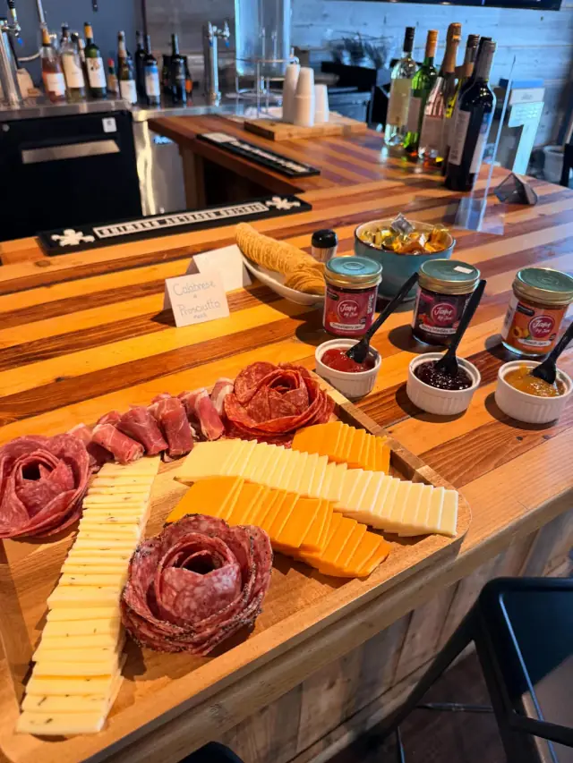 A charcuterie board built at The Butcher's Pantry with salami roses, cheese and jam