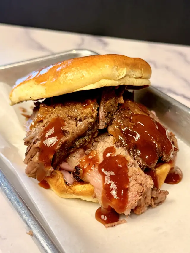 House smoked pulled pork sandwich with barbecue sauce