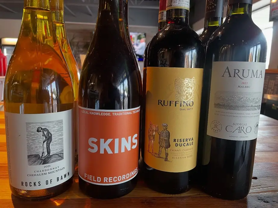 A curated line of wine bottles along the bar at The Butcher's Pantry in Solon